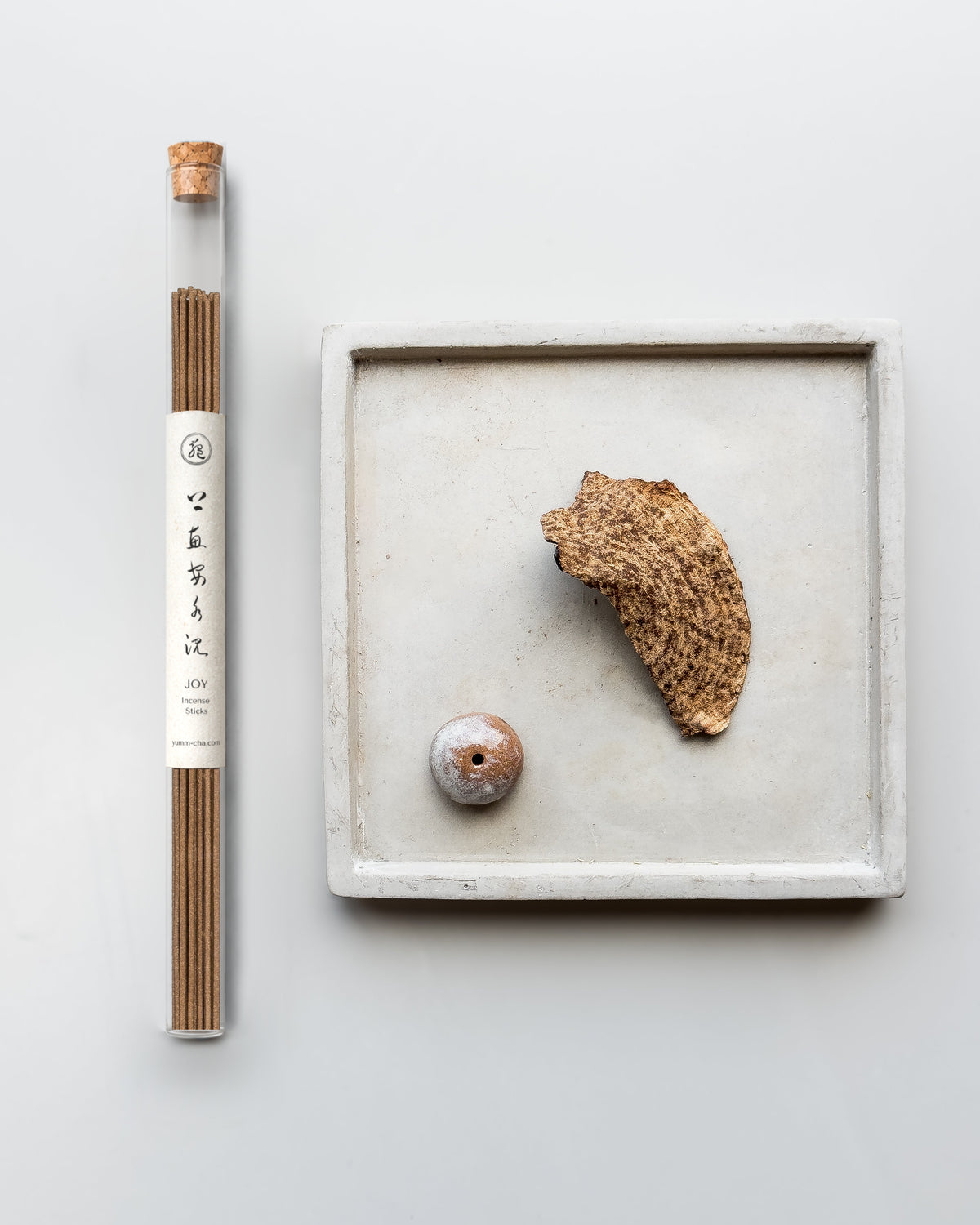 JOY incense sticks in a cork-stoppered glass tube