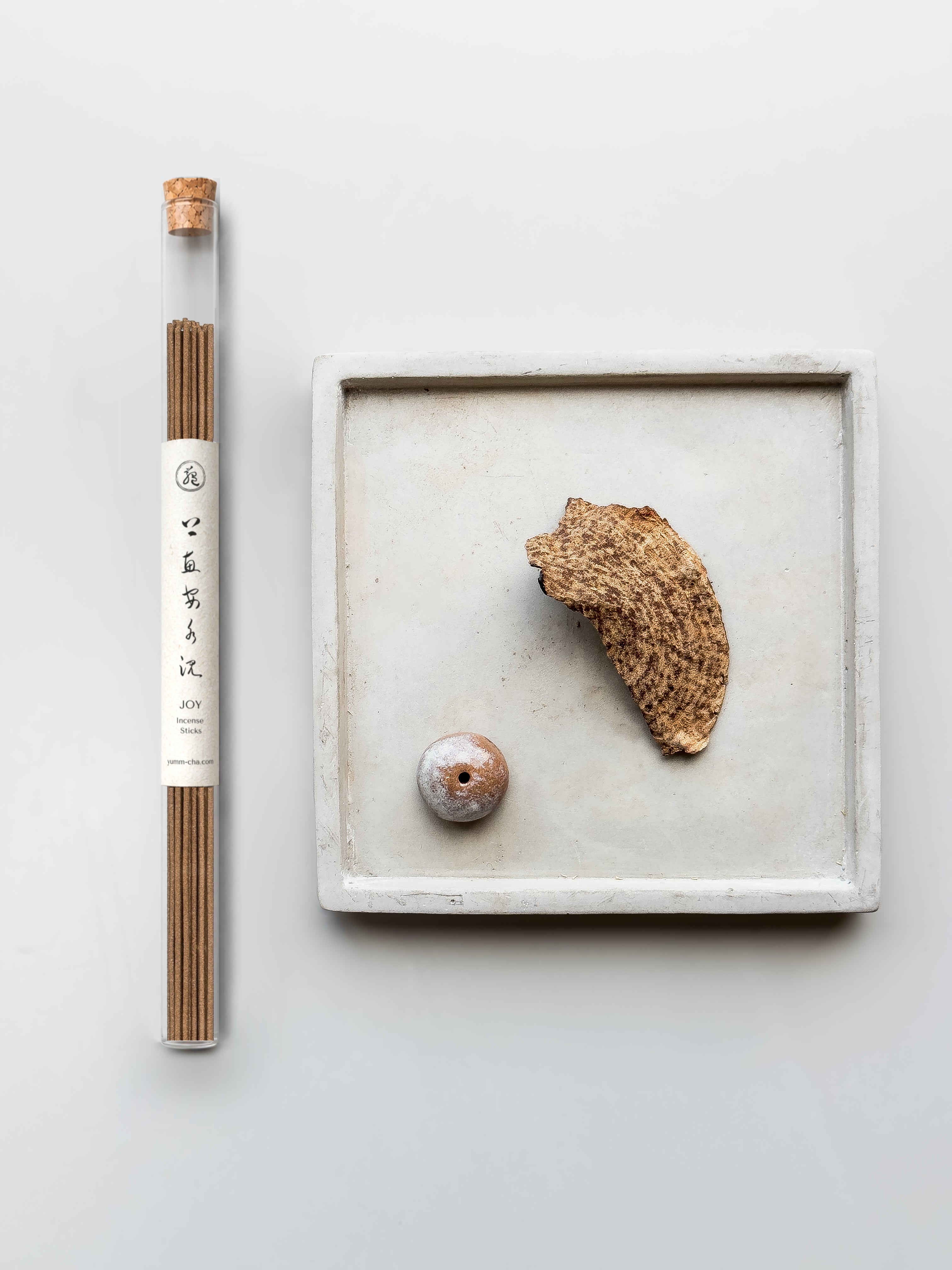 JOY incense sticks in a cork-stoppered glass tube