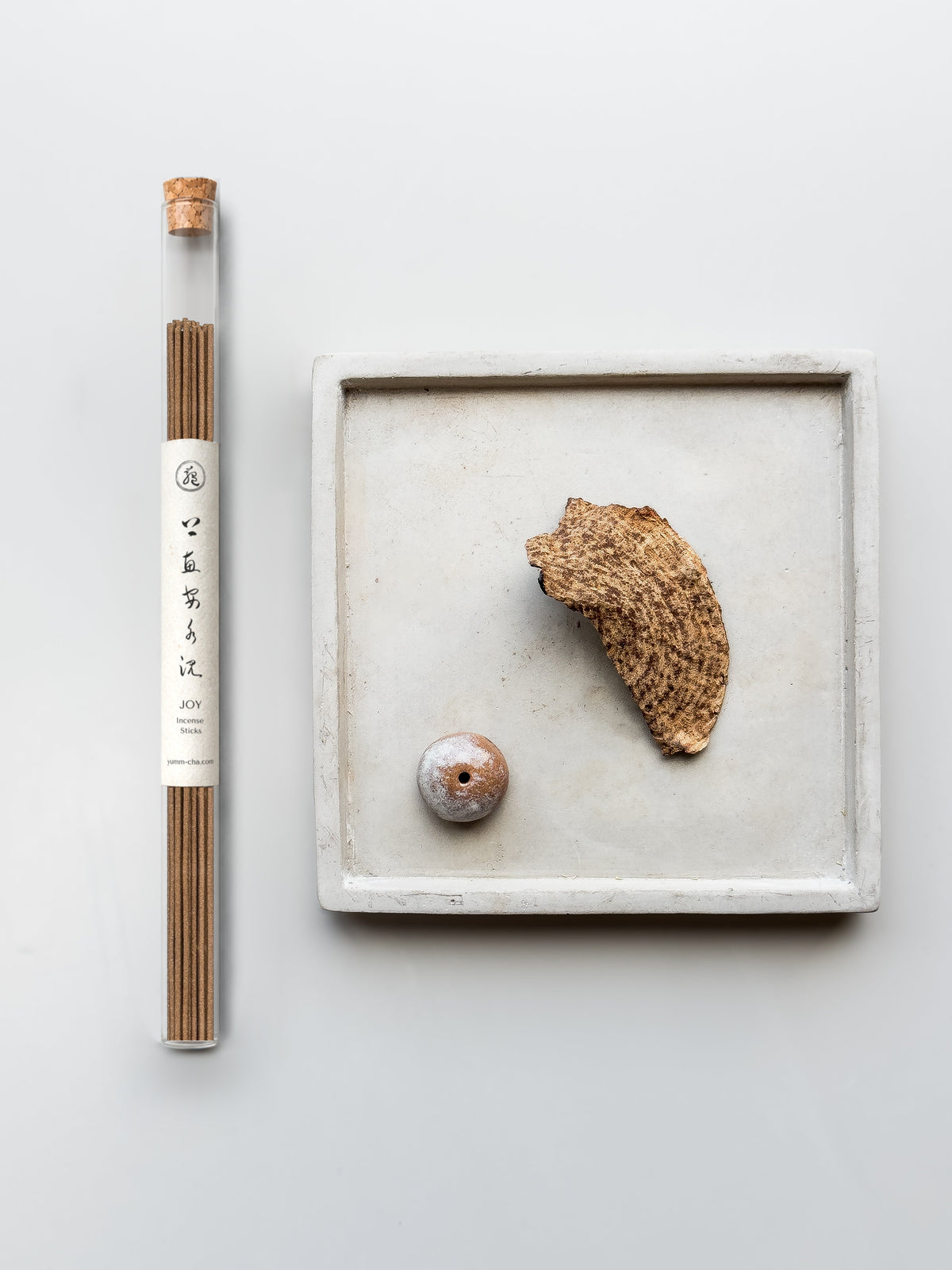 JOY incense sticks in a cork-stoppered glass tube